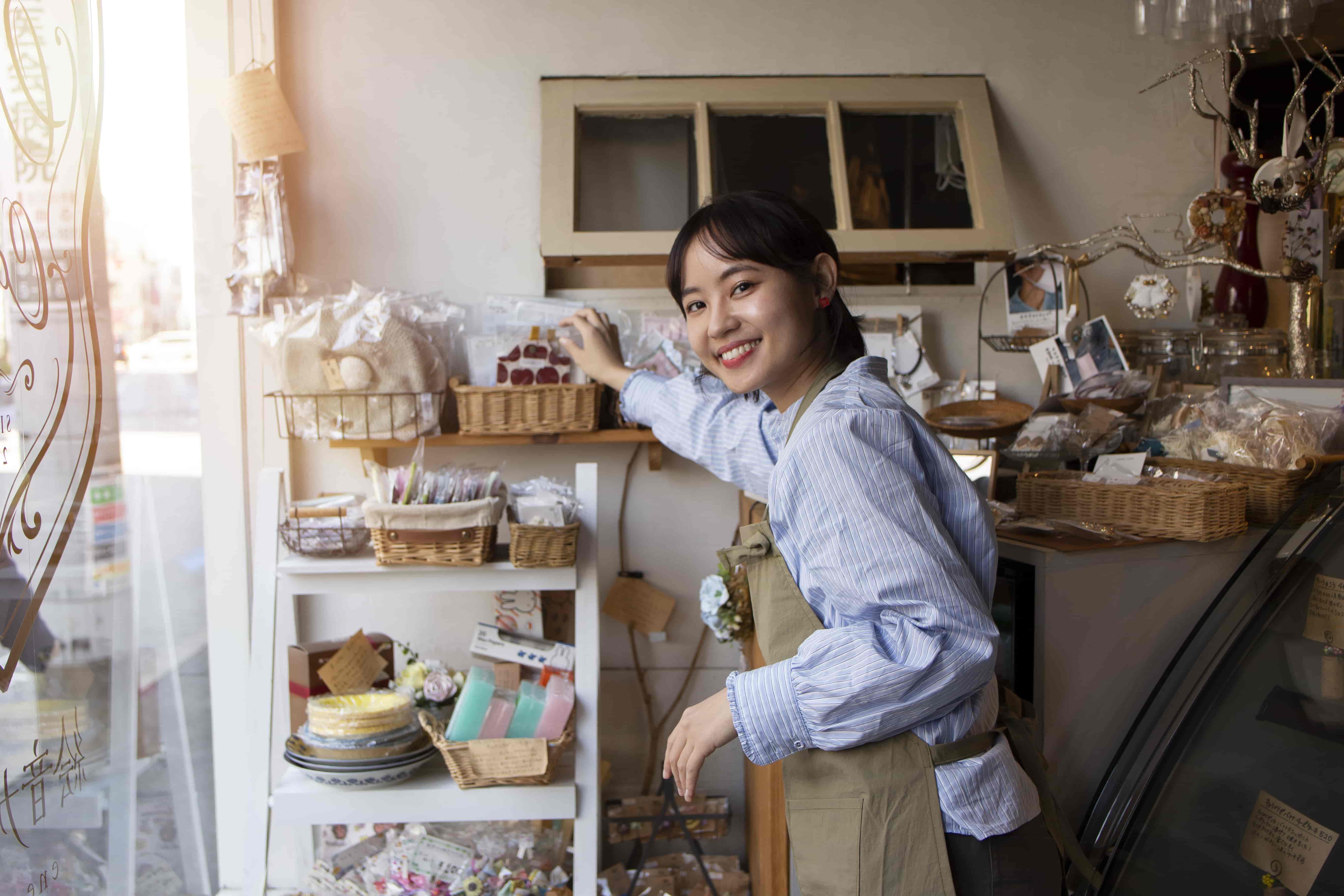young woman arranging her cake shop